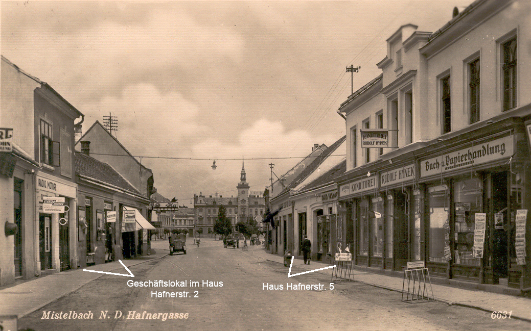 Diese in der NS-Zeit herausgegebene Postkarte nutzt eine Aufnahme aus der Zeit vor dem "Anschluss" (etwa 1935) und zeigt das Geschäft Lustigs in der Hafnerstraße 2 und das ihm gehörige Haus Hafnerstr. 5 in dem das Geschäft von David Kasmacher erkennbar ist.